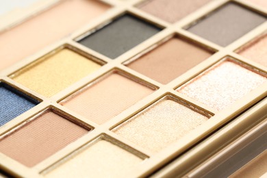 Photo of Beautiful eyeshadow palette as background, closeup. Cosmetic product