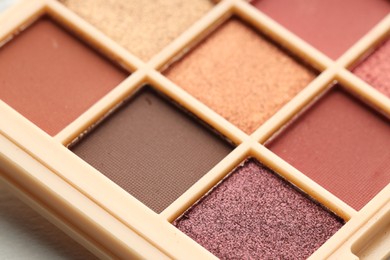 Photo of Beautiful eyeshadow palette as background, closeup. Cosmetic product