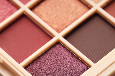 Photo of Beautiful eyeshadow palette as background, closeup. Cosmetic product