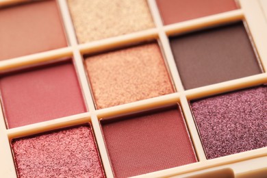 Photo of Beautiful eyeshadow palette as background, closeup. Cosmetic product