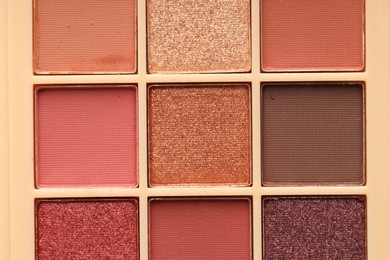 Photo of Beautiful eyeshadow palette as background, top view