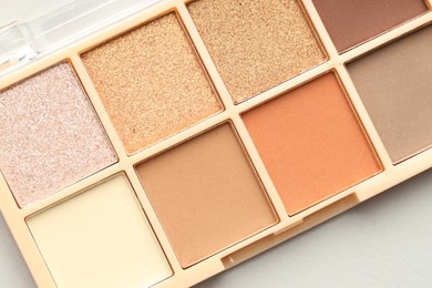 Photo of Beautiful eyeshadow palette on white background, top view