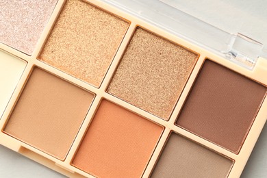 Photo of Beautiful eyeshadow palette on white background, top view