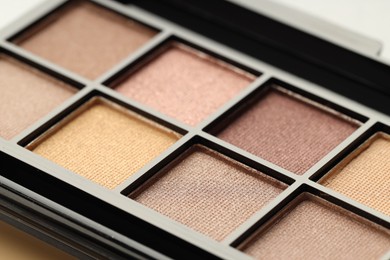 Photo of Beautiful eyeshadow palette as background, closeup. Cosmetic product