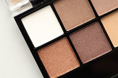 Photo of Beautiful eyeshadow palette on white background, top view