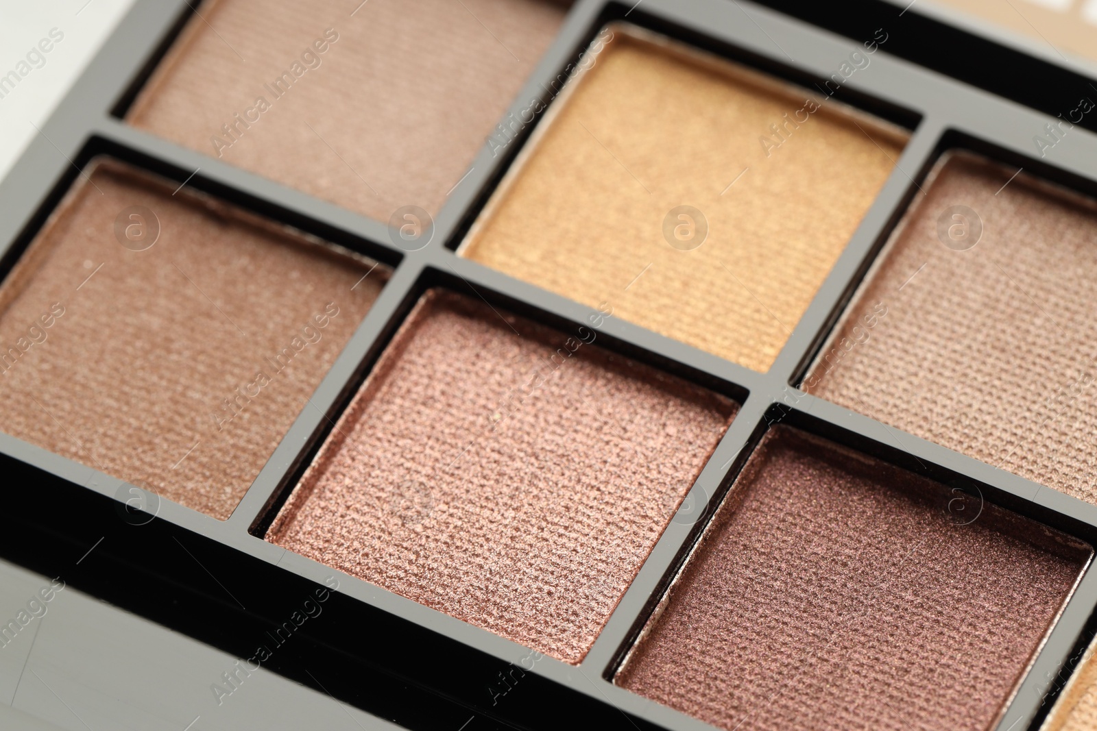 Photo of Beautiful eyeshadow palette as background, closeup. Cosmetic product