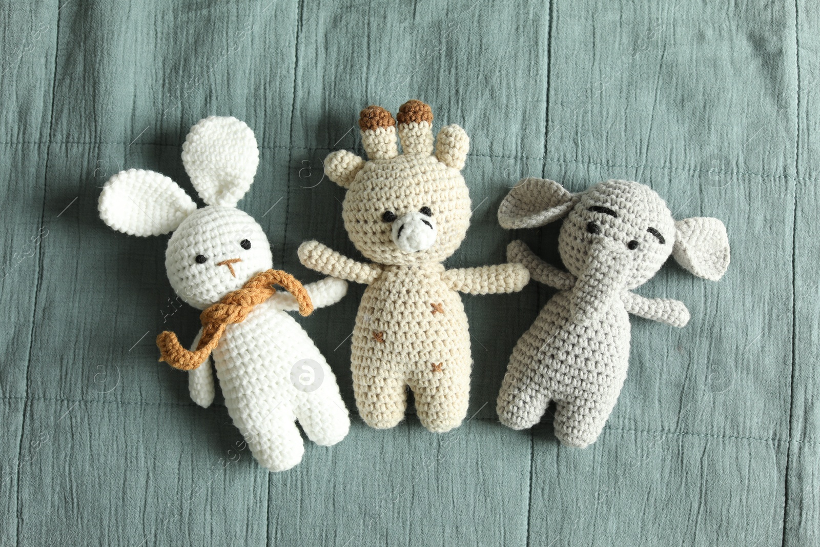 Photo of Cute soft toys on grey fabric, top view