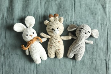 Photo of Cute soft toys on grey fabric, top view