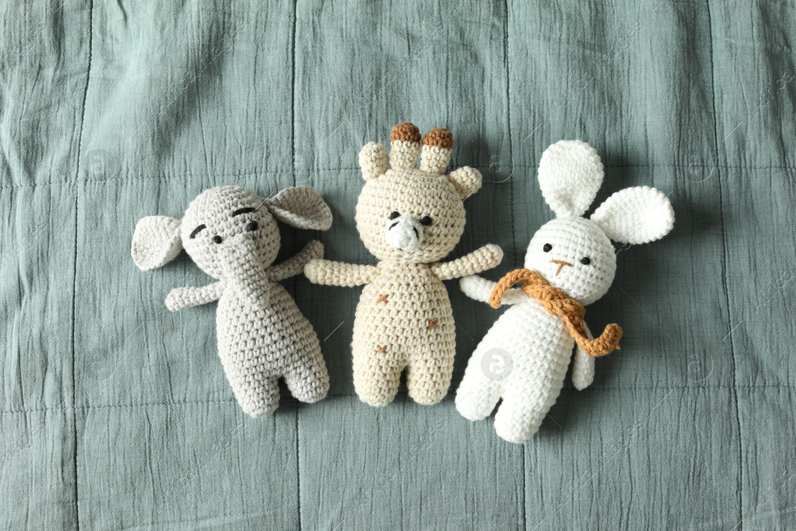 Photo of Cute soft toys on grey fabric, top view