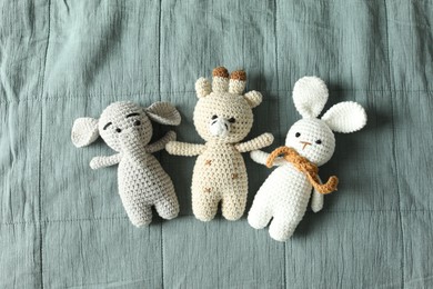 Photo of Cute soft toys on grey fabric, top view