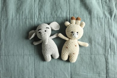 Photo of Cute soft toys on grey fabric, top view
