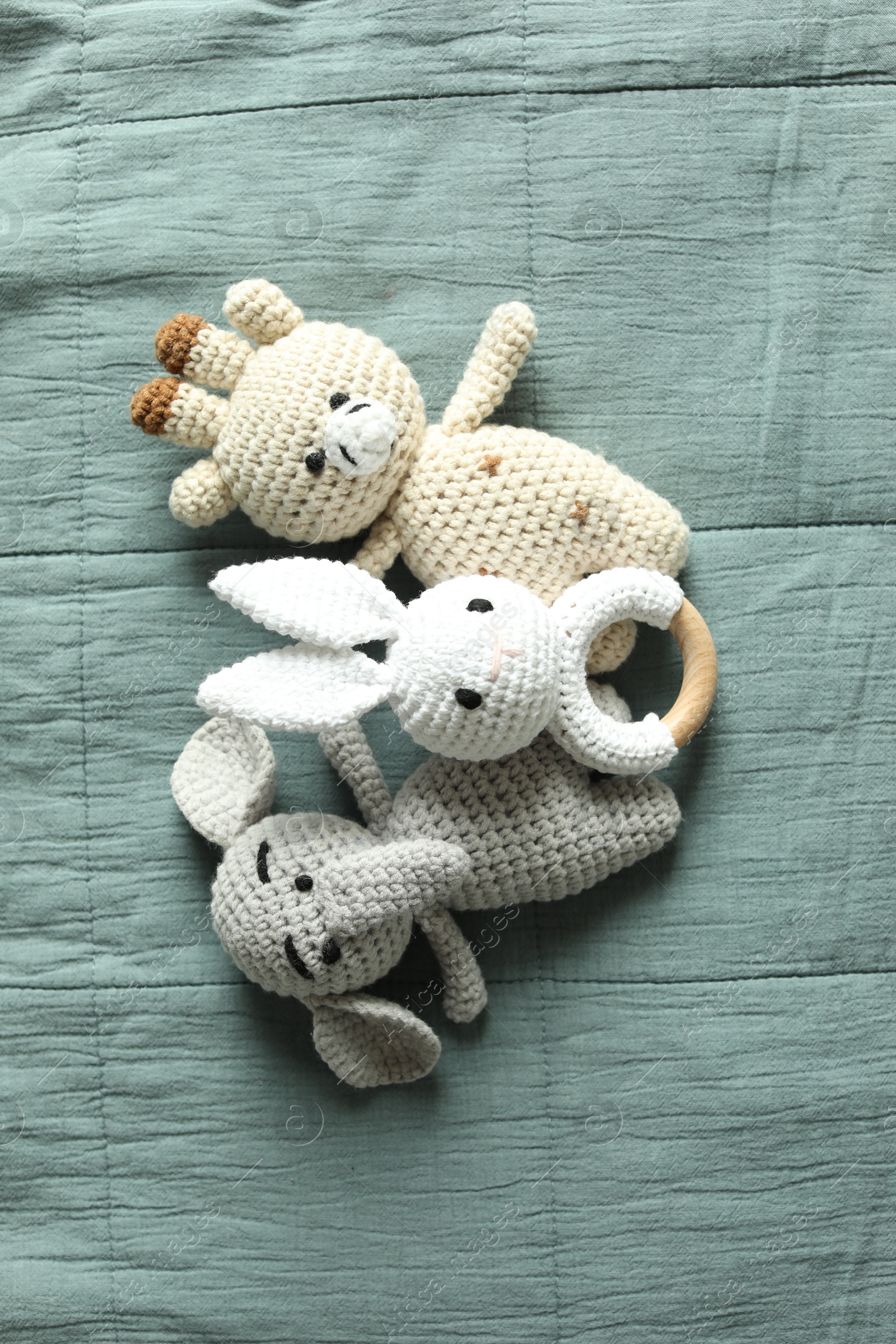 Photo of Cute soft toys on grey fabric, top view