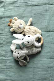Photo of Cute soft toys on grey fabric, top view