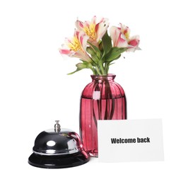Photo of Card with word Welcome, desk bell and vase with flowers isolated on white