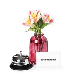 Photo of Card with word Welcome, desk bell and vase with flowers isolated on white