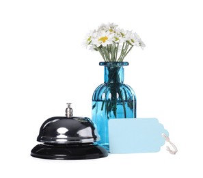 Photo of Blank card, desk bell and vase with flowers isolated on white