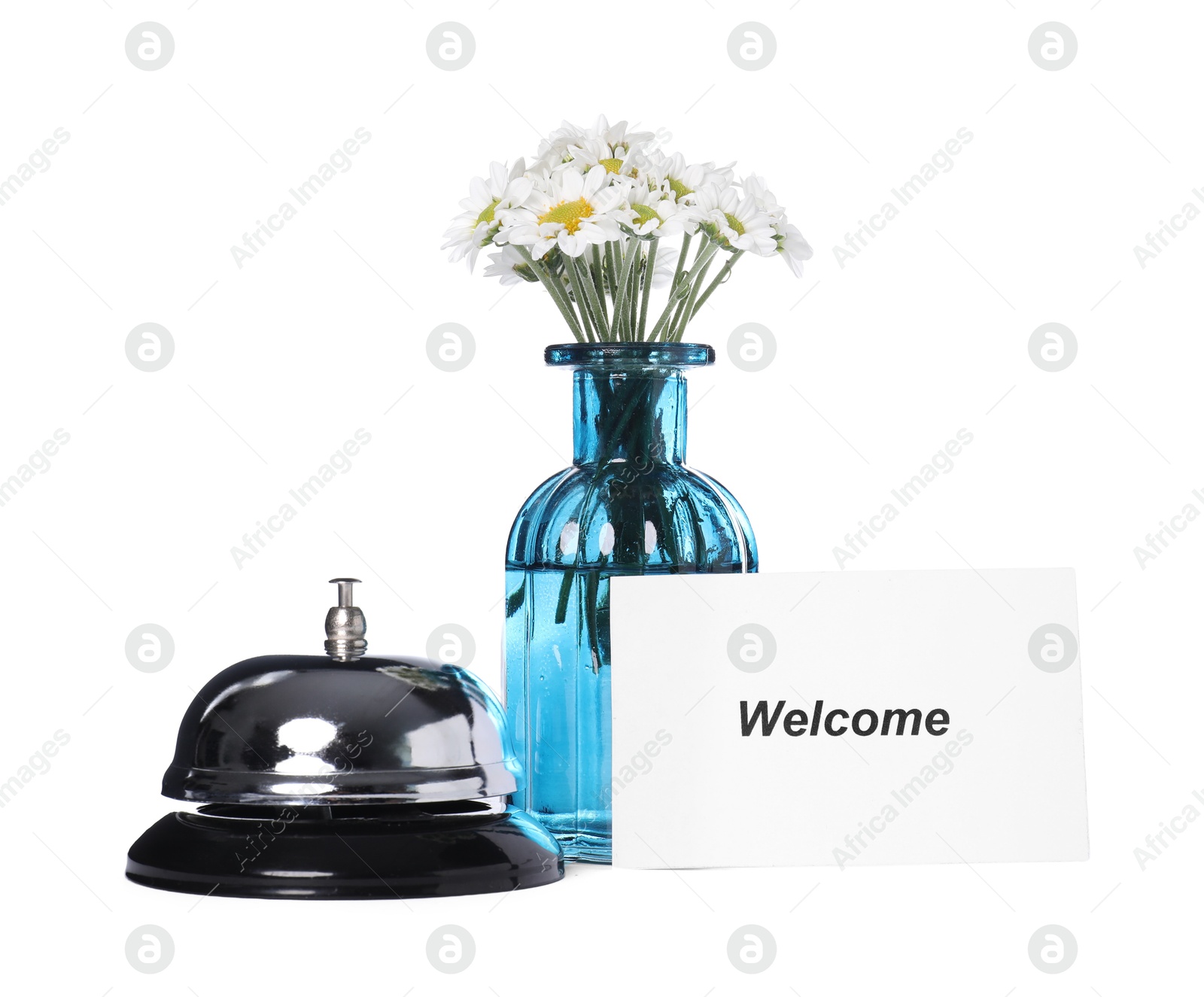 Card with word Welcome, desk bell and vase with flowers isolated on white Photo of Card with word Welcome, desk bell and vase with flowers isolated on white