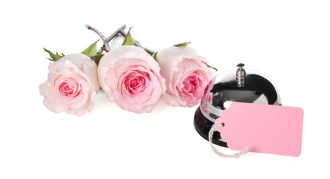 Photo of Blank card, desk bell and roses isolated on white
