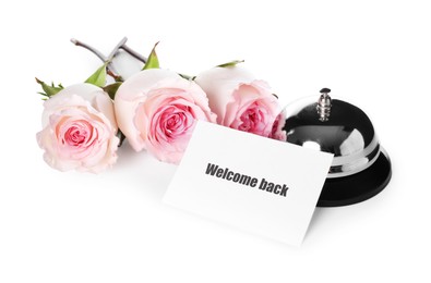 Photo of Card with word Welcome, desk bell and roses isolated on white