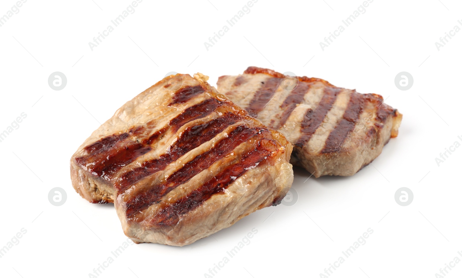 Steaks of delicious grilled beef meat isolated on white Photo of Steaks of delicious grilled beef meat isolated on white