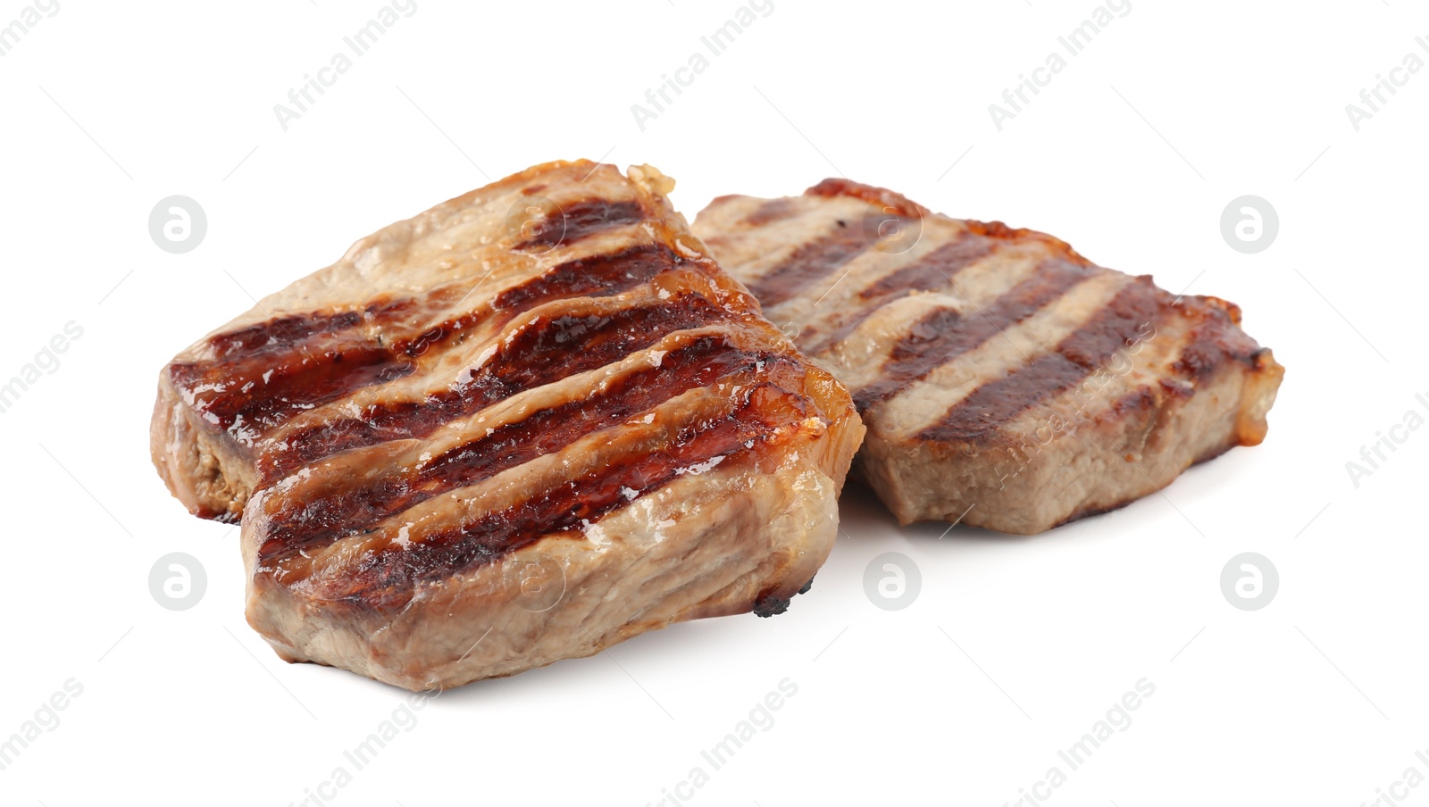 Steaks of delicious grilled beef meat isolated on white Photo of Steaks of delicious grilled beef meat isolated on white