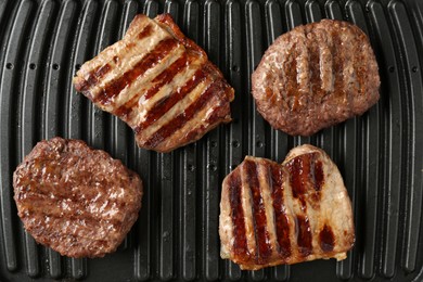 Photo of Electric grill with beef meat, top view