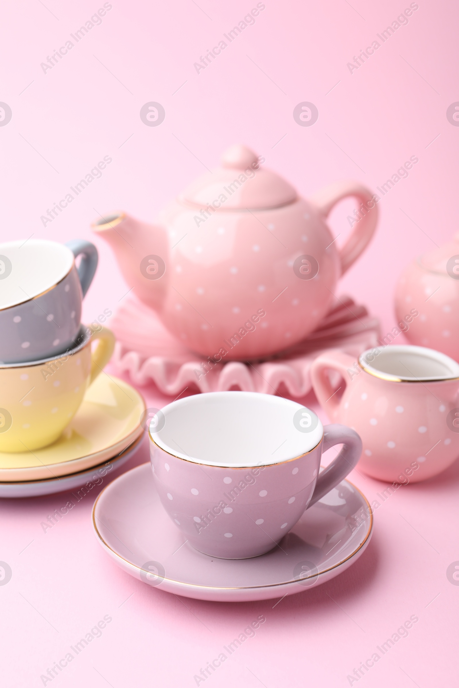 Photo of Beautiful tea set on pink background. Child's toy