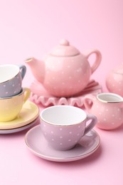 Photo of Beautiful tea set on pink background. Child's toy