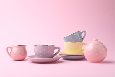 Photo of Beautiful tea set on pink background, space for text. Child's toy