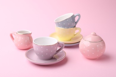 Photo of Beautiful tea set on pink background. Child's toy