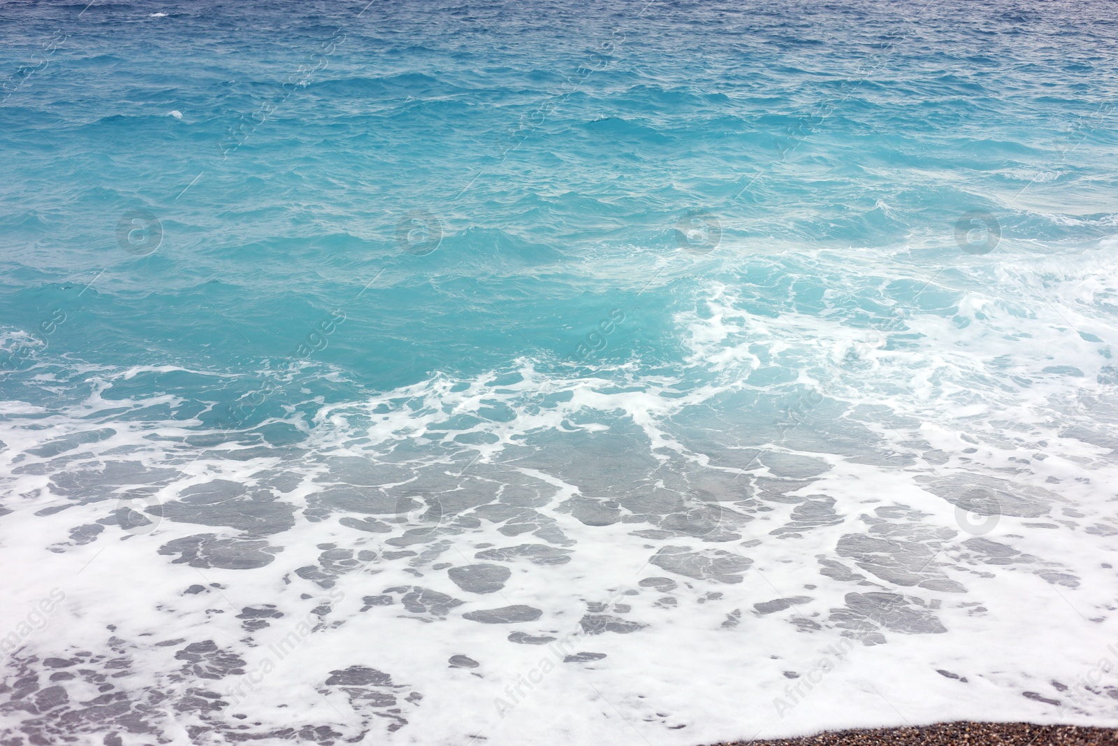 Photo of Beautiful view of wavy sea and pebbles on beach