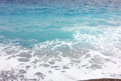 Photo of Beautiful view of wavy sea and pebbles on beach
