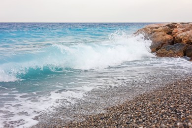 Photo of Beautiful view of wavy sea and pebbles on beach