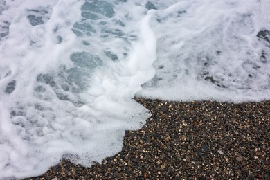Photo of Beautiful view of wavy sea and pebbles on beach