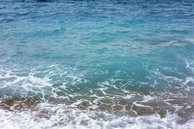 Photo of Beautiful view of wavy sea and pebbles on beach
