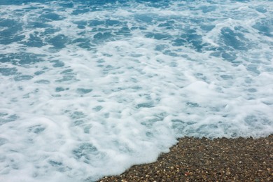 Photo of Beautiful view of wavy sea and pebbles on beach