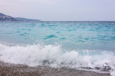 Photo of Beautiful view of wavy sea and pebbles on beach