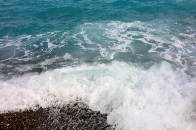 Photo of Beautiful view of wavy sea and pebbles on beach