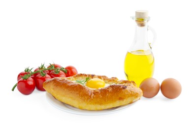 Photo of Tasty khachapuri with eggs, tomatoes and oil isolated on white