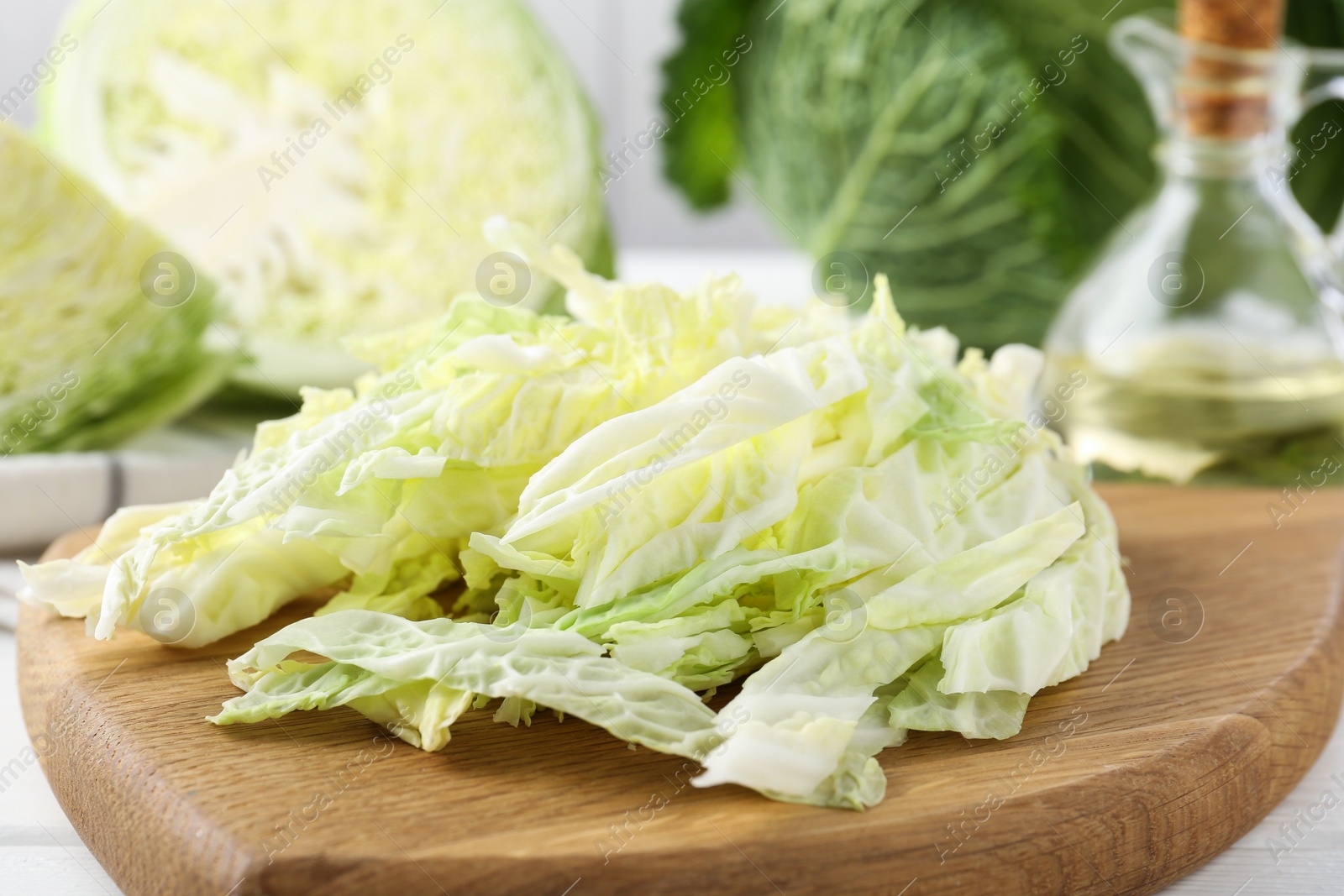 Photo of Fresh cut Savoy cabbage on white table, closeup