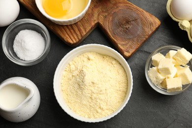 Photo of Cornbread preparation. Different ingredients on black textured table, flat lay