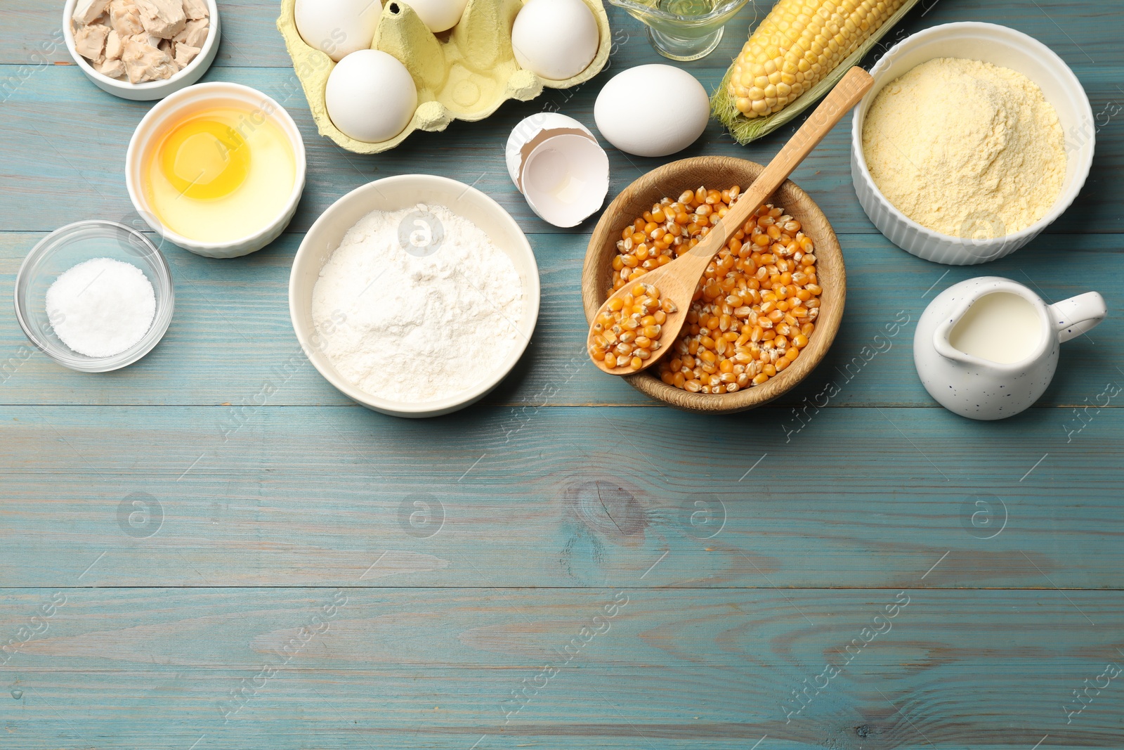 Cornbread preparation. Different ingredients on light blue wooden table, flat lay. Space for text Photo of Cornbread preparation. Different ingredients on light blue wooden table, flat lay. Space for text