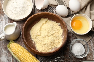 Photo of Making cornbread. Different ingredients and metal whisk on wooden table, flat lay