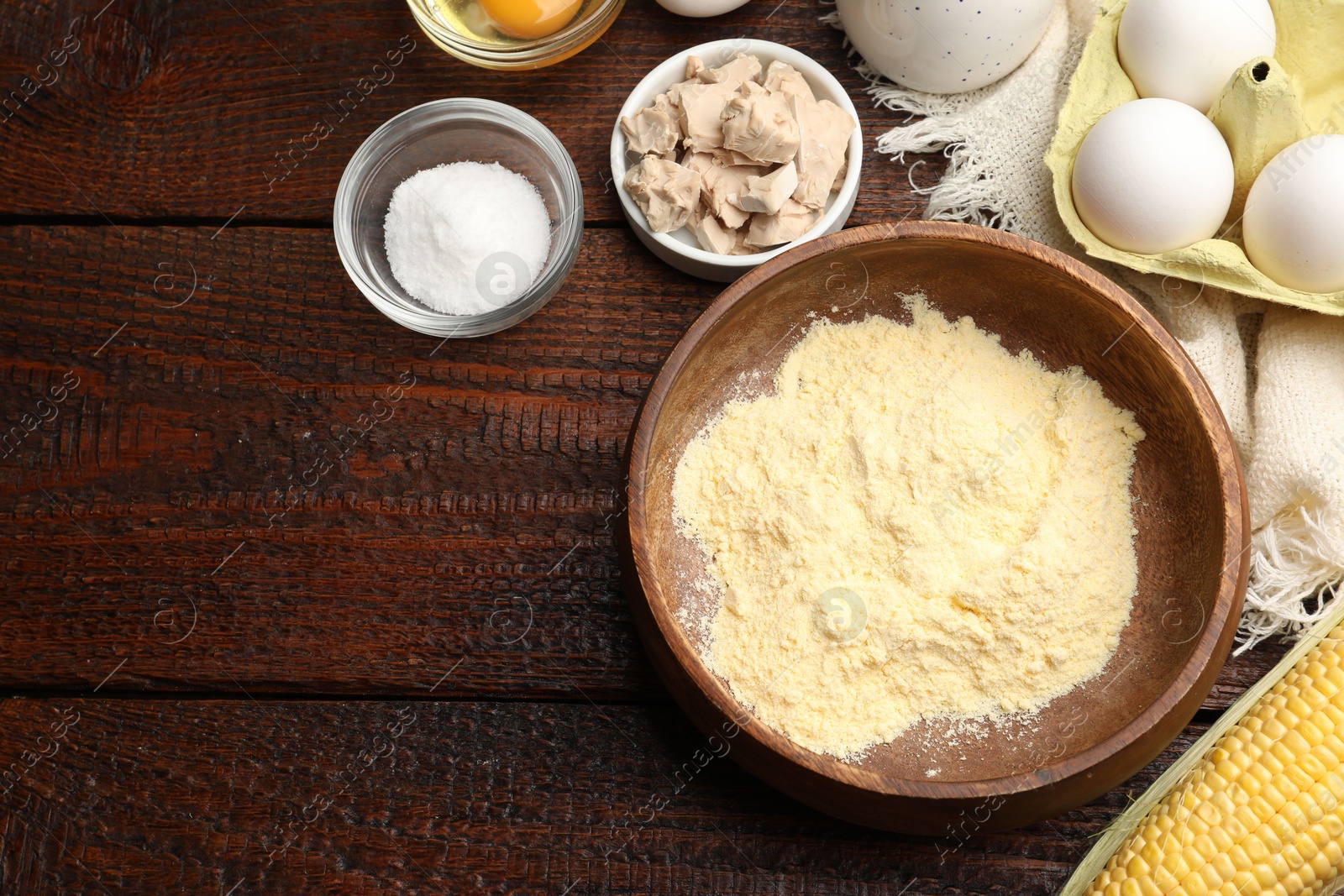 Cornbread preparation. Different ingredients on wooden table, flat lay. Space for text Photo of Cornbread preparation. Different ingredients on wooden table, flat lay. Space for text
