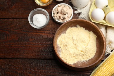 Photo of Cornbread preparation. Different ingredients on wooden table, flat lay. Space for text