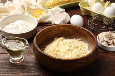 Photo of Making cornbread. Different ingredients on wooden table, closeup