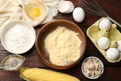 Photo of Making cornbread. Different ingredients and metal whisk on wooden table, flat lay