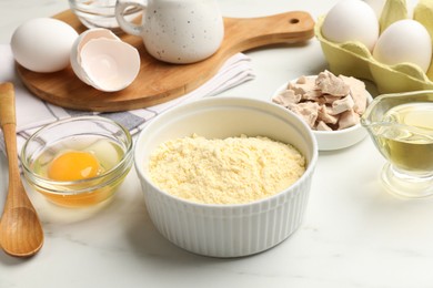 Photo of Making cornbread. Different ingredients on white marble table, closeup