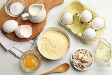 Photo of Making cornbread. Different ingredients on white marble table, flat lay