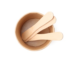 Photo of Disposable cup and wooden sticks isolated on white, top view